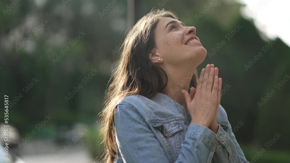 Spiritual person thanking God. Young woman feeling grateful having HOPE and FAITH. Happy girl celebrating success Spiritual person thanking God. Young woman feeling grateful having HOPE and FAITH. Happy girl celebrating success