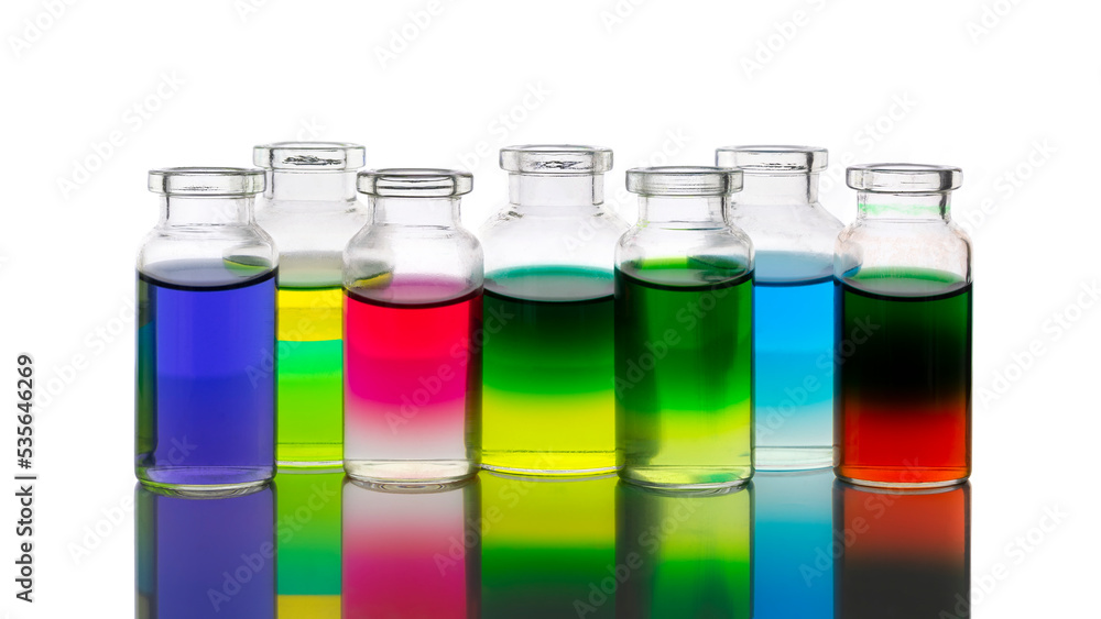 Colored water layers in small glass bottles isolated on white background Colored water layers in small glass bottles isolated on white background