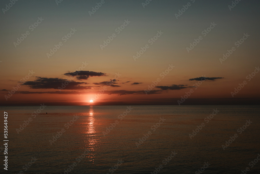 Magic sunset on the sea. Ocean at dawn. Travel to the islands. Postcard for a travel agency