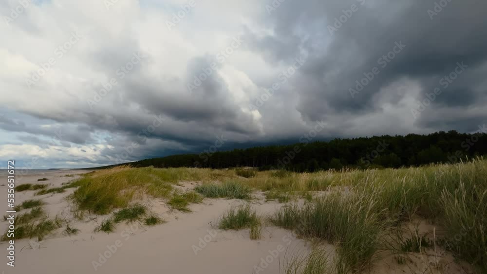 Moody and gloomy stormy sky over windy baltic sea and sandy beach Moody and gloomy stormy sky over windy baltic sea and sandy beach