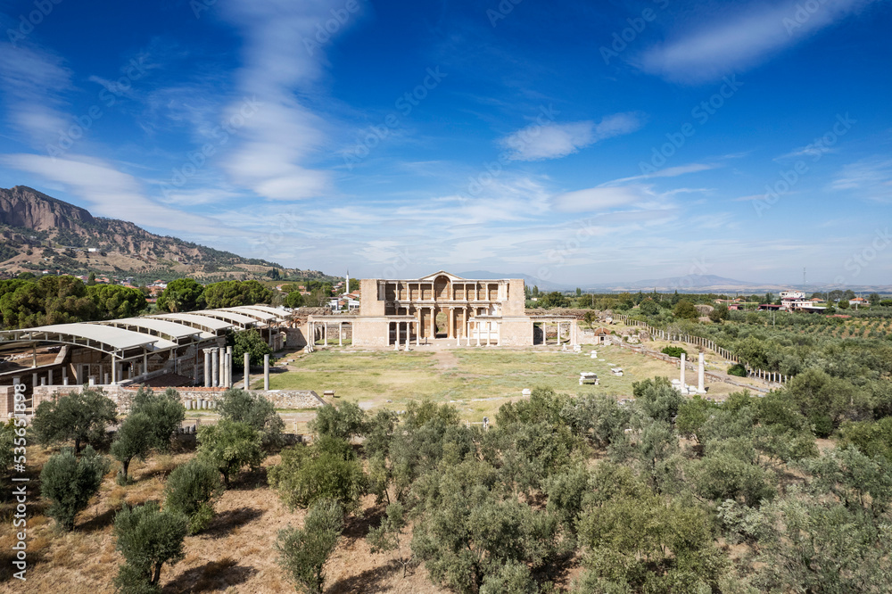 Aerial view with drone; Sardes (Sardis) Ancient City which has gymnasium and synagogue ruins and columns in Manisa, Turkey.