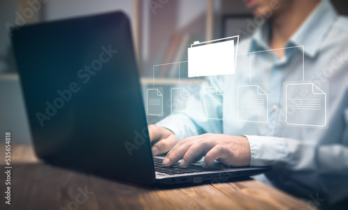 Files on a virtual screen. man working with laptop