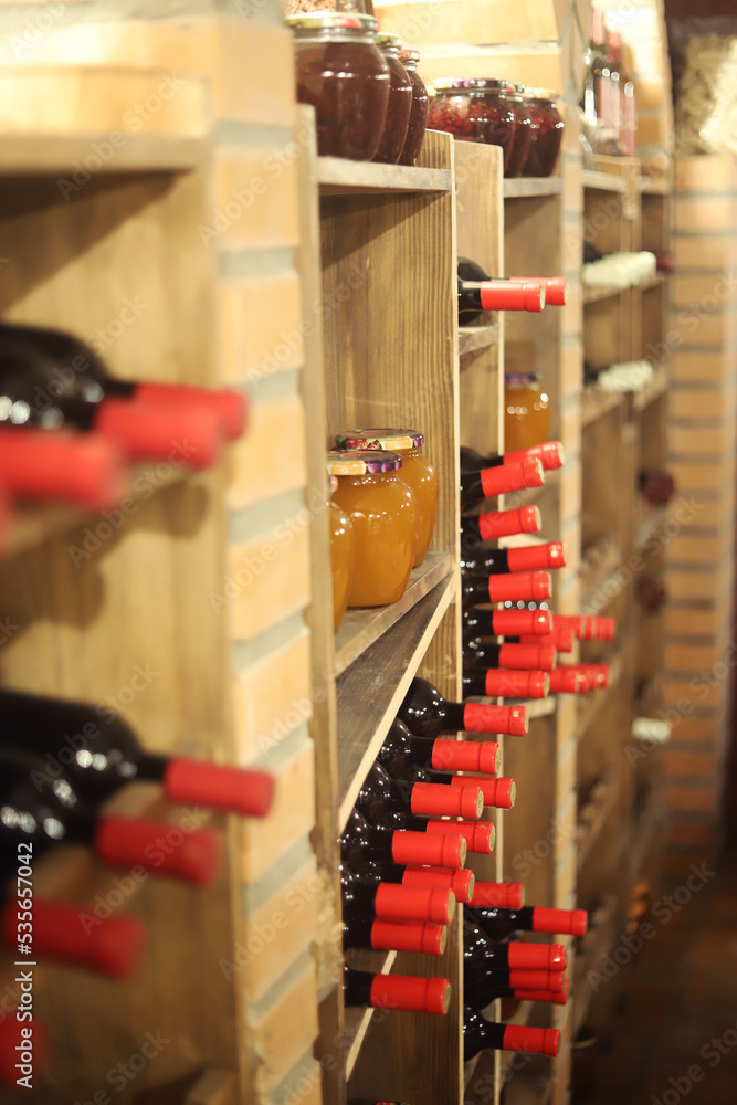 sealed wine bottles and jams on the cellar shelves sealed wine bottles and jams on the cellar shelves