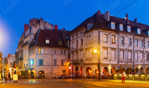 Evening view of illuminated lively historic center of French city of Besancon in summer.