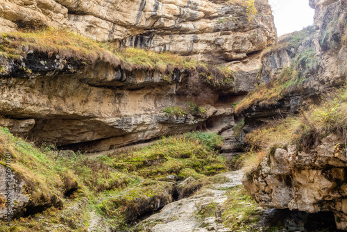 Saltinsky canyon in Salta, Dagestan, Russia. The path to the underground waterfall along the Bakdakuli River. Beautiful canyon in sunny weather. Limestone rocks. Natural background. Travel concept