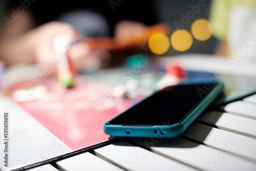 Detail of a green smart phone on a table