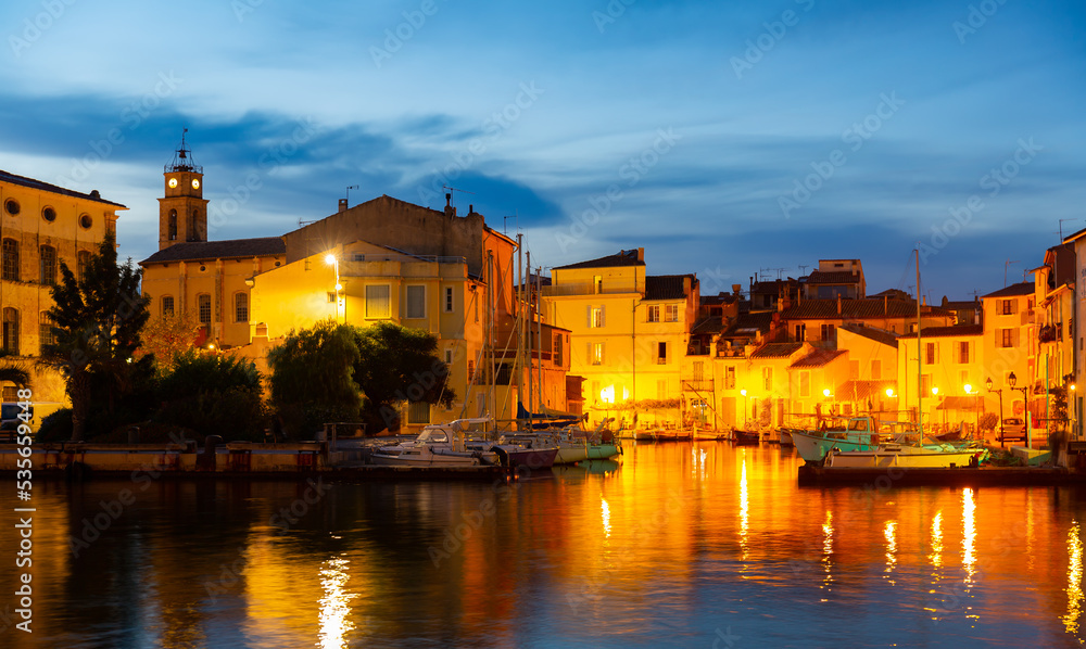 View of evening embankment with illuminations of the city of Martigues. France