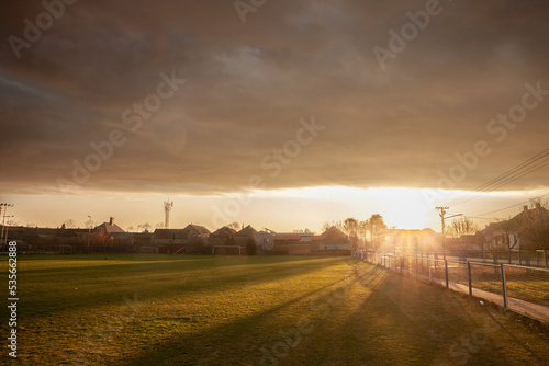 Panorama of a sunset over a rural european football field (a soccer playground), in a small agricultural village in Serbia...