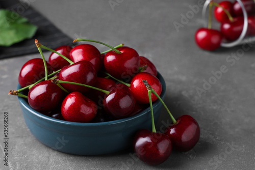 Fresh ripe cherries on grey table, closeup