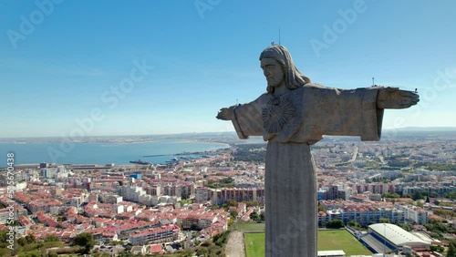 Aerial drone view. Flying around the Jesus statue in Lisbon Portugal. Ponte 25 de abril. Bridge over the ocean