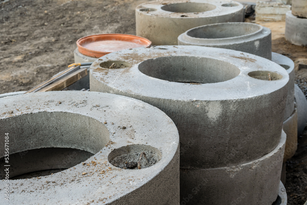 Blocks for construction. Concrete big pipes at construction site. Industrial background Blocks for construction. Concrete big pipes at construction site. Industrial background
