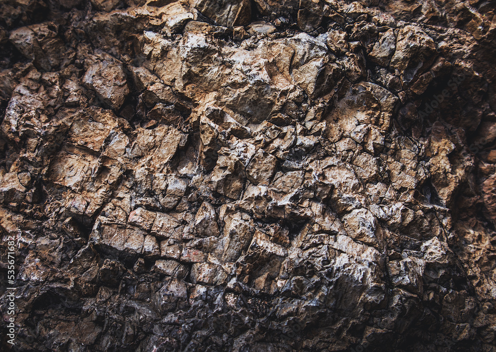 Fototapeta premium Brown texture. Stone background. Rock texture. Grunge Rough structure. Abstract texture. Rock surface with cracks. Rock pile. Paint spots wall. Wall marble.