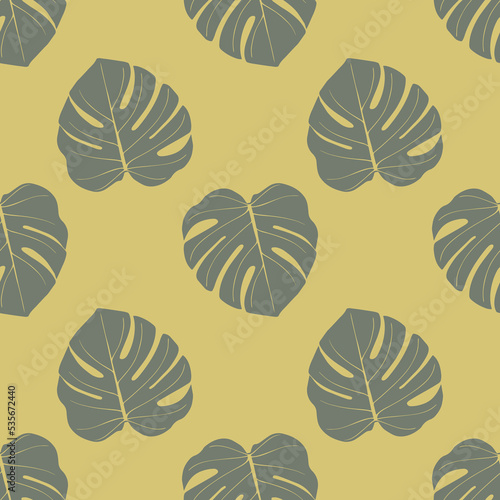 Seamless pattern with tropical leaves in a natural green palette.