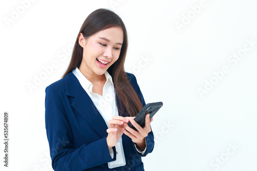 female manager wearing a blue suit Holding a black smartphone standing on a white background. Concept of business woman, entrepreneur. Modern communication technology. Social online.