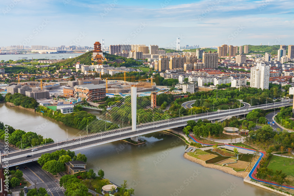 Overlooking the skyline and canal bridge of modern urban architecture in Jiangyin, China Overlooking the skyline and canal bridge of modern urban architecture in Jiangyin, China