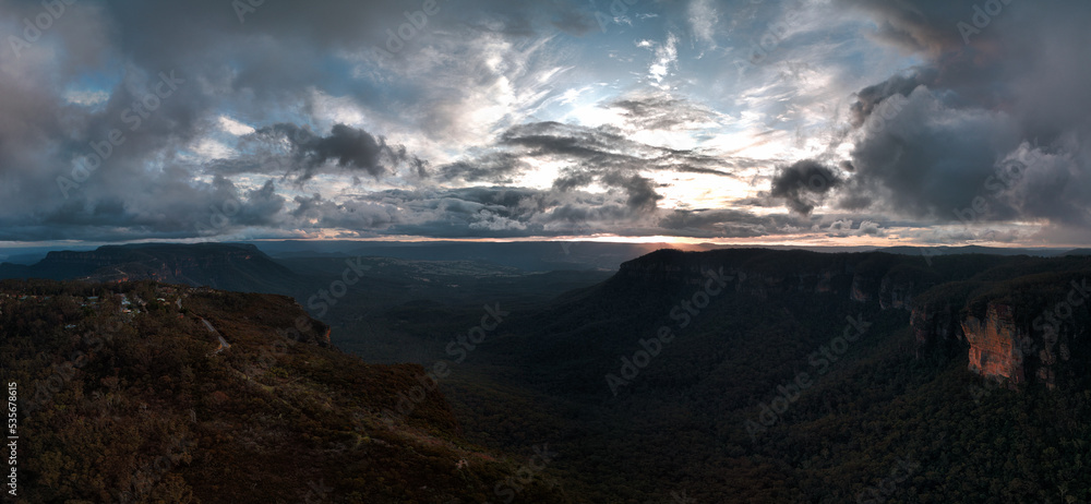 Panorama of mountains and valley and dramatic sunset