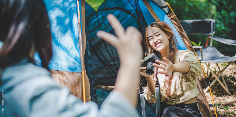 Young woman use camera taking photo and show her friends Young woman use camera taking photo and show her friends