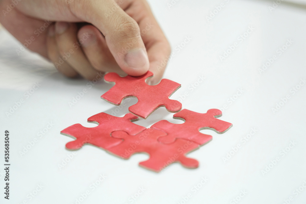 Prson assembling puzzles, finding solution. Prson assembling puzzles, finding solution.