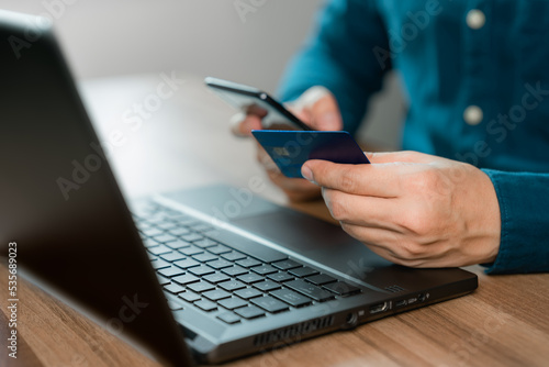 Man using credit card for purchasing and shopping online on mobile phone. Mobile payment with wallet app technology. Digital money transfer, banking and e commerce concept.