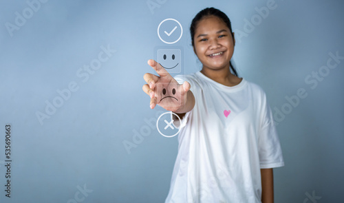 Hand choosing happy smile icon. represents feedback rating and positive customer review.