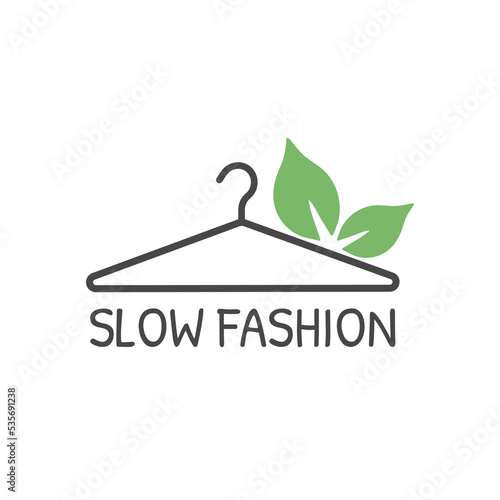 Hanger with green leaves and  text slow fashion. Label, badge or logo. Slow fashion icon. Vector illustration