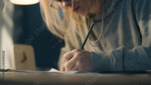 Female creative designer looks at her sketches critically for final touch ups. Blows away the eraser crumbs. Pencil sketch. Storyboard  video editing  comics compilation  creative work concept.