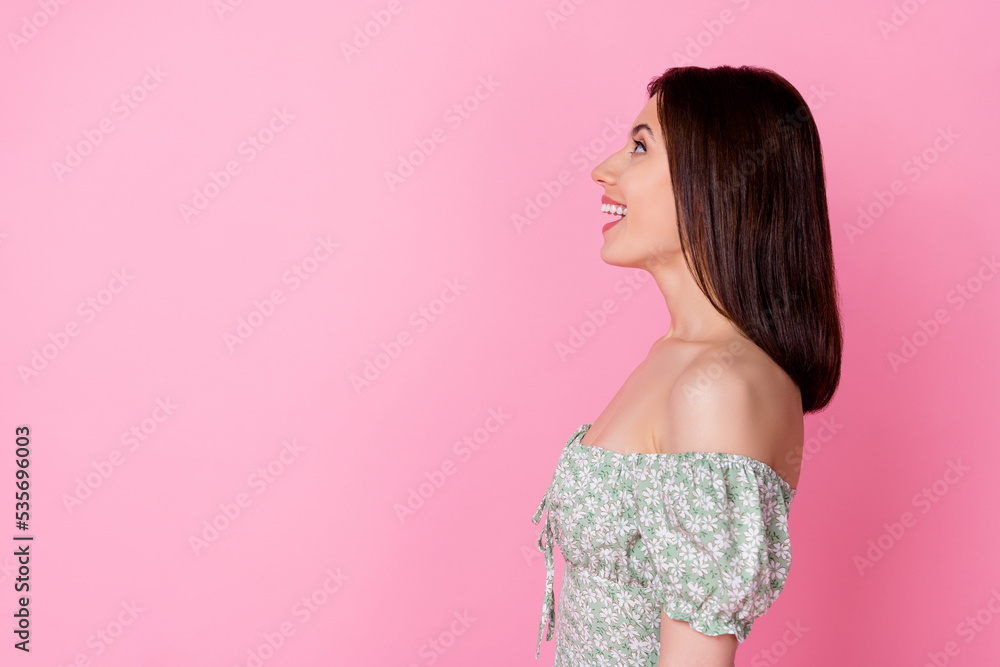 Profile photo of impressed millennial brunette lady look up wear dress isolated on pink color background Profile photo of impressed millennial brunette lady look up wear dress isolated on pink color background