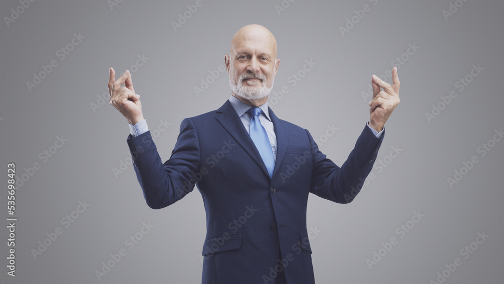Smiling corporate businessman snapping fingers Smiling corporate businessman snapping fingers