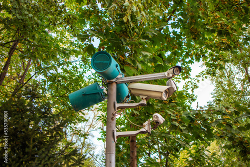 Canvas Print camera and loudspeaker on a pole in the park