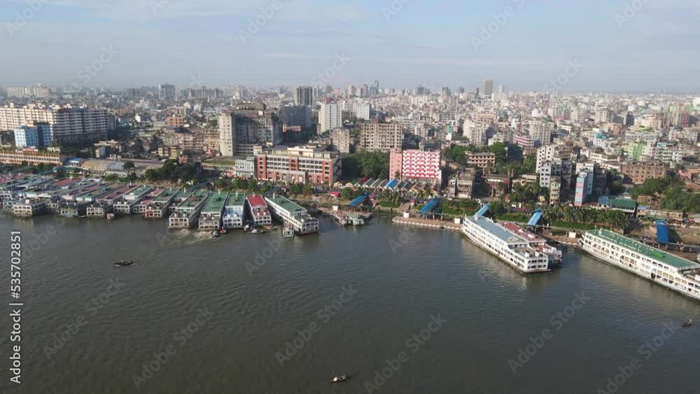 Aerial view of Dhaka cityscape Sprawling in Horizon, Boats cruise and moored at Buriganga river, Bangladesh Aerial view of Dhaka cityscape Sprawling in Horizon, Boats cruise and moored at Buriganga river, Bangladesh