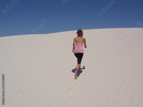 Fit Female Running Up White Sand Dune 