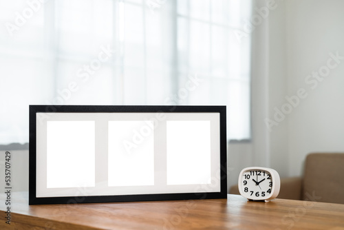 Style picture frame still life put on the wooden table in living room. Blank space empty picture frame with mockup. Natural light Template background interior design and decoration