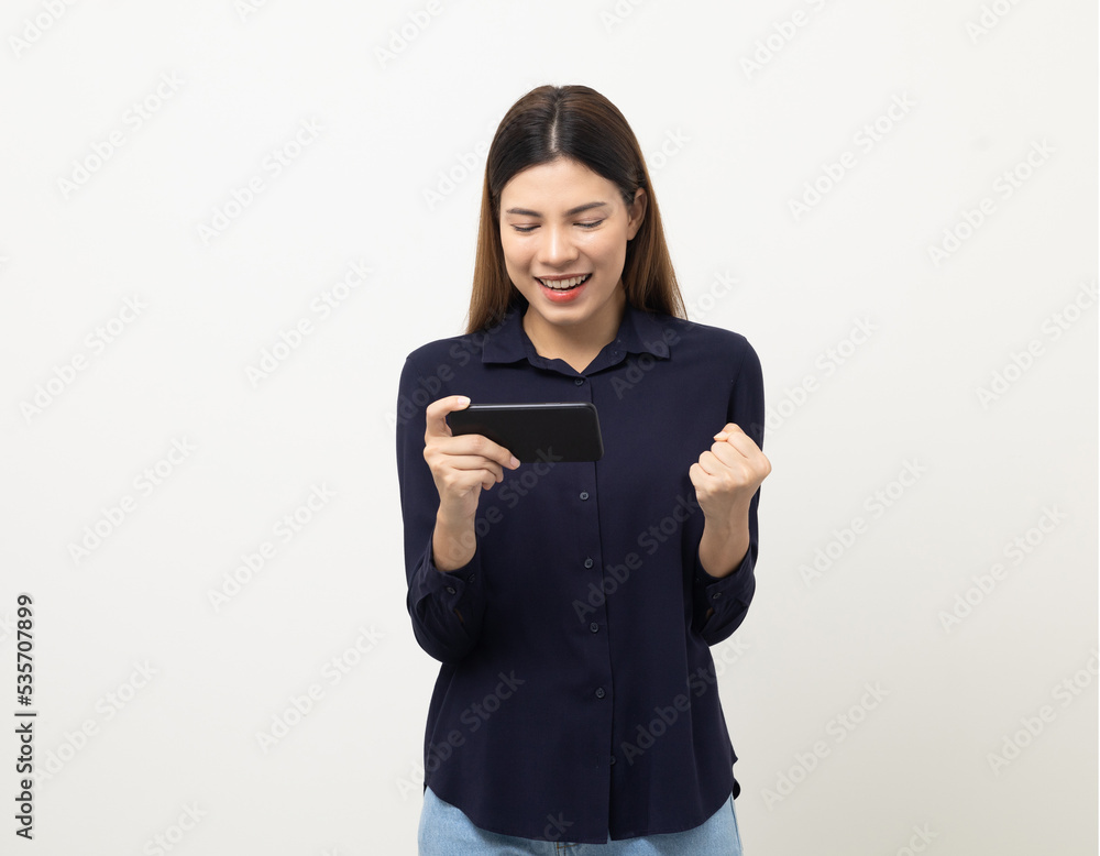 Pretty young mixed race woman using smartphone standing on isolated white background. She texting on cell phone. Feeling happy and excited Pretty young mixed race woman using smartphone standing on isolated white background. She texting on cell phone. Feeling happy and excited