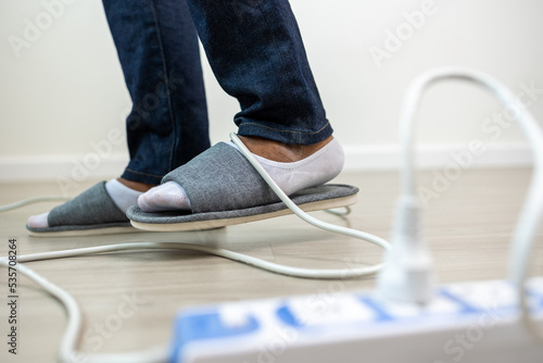 A man stumbles upon a cluttered wire lying on the ground. Stumbled until the head hit the ground. Accident at home It is because of carelessness and clumsiness electric shock photo