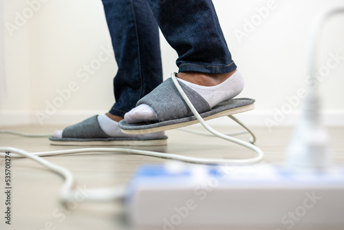 A man stumbles upon a cluttered wire lying on the ground. Stumbled until the head hit the ground. Accident at home It is because of carelessness and clumsiness electric shock photo