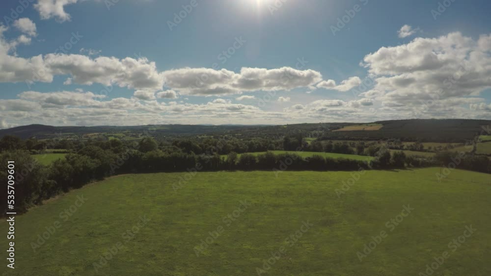 Slowly flying out over the beautiful green rolling fields of Ireland. A recent drought in the area has caused the fields to turn a mix or green and brown as the grass dries out. Slowly flying out over the beautiful green rolling fields of Ireland. A recent drought in the area has caused the fields to turn a mix or green and brown as the grass dries out.