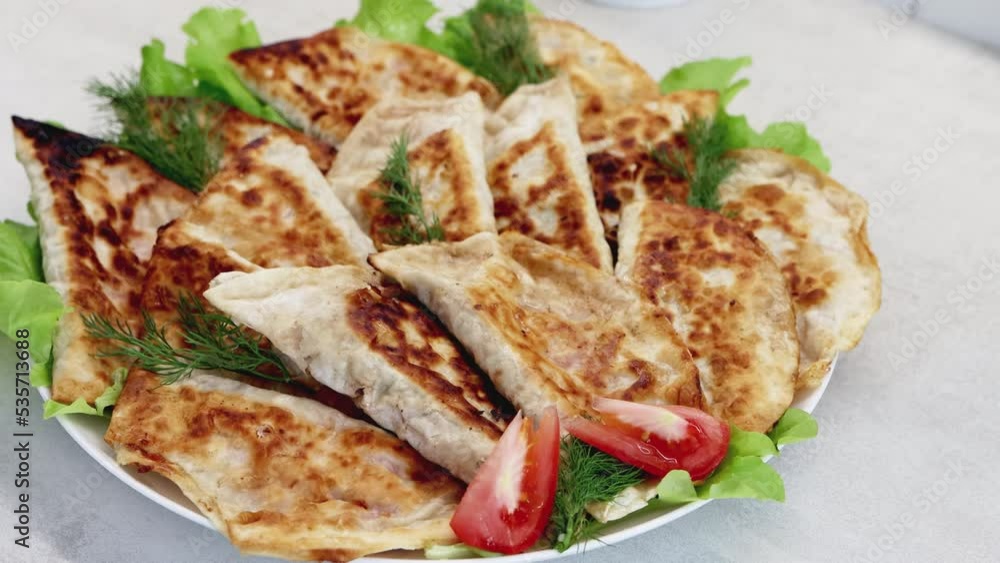 Dish with delicious fried chebureks made from dough and minced meat. Homemade fast food. Close-up