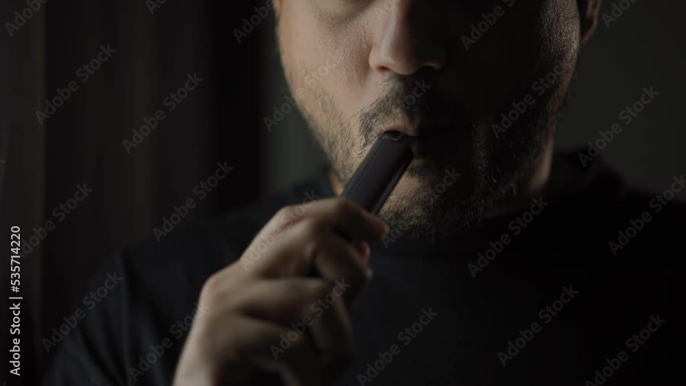 Close-up mouth of man smoke inhaling, breathing and smoke electronic cigarette.
Close-up mouth of man smoke inhaling, breathing and smoke electronic cigarette.