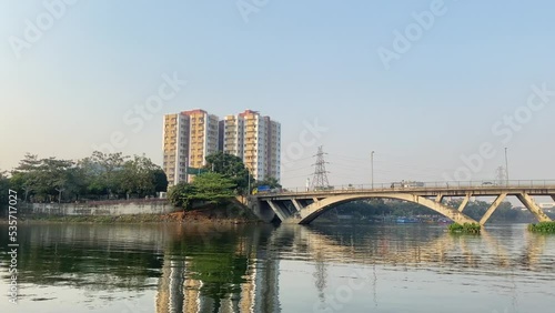 Panning shot of Hatirjheel South bridge reflected on Water surface, Dhaka Cityscape, Bangladesh photo