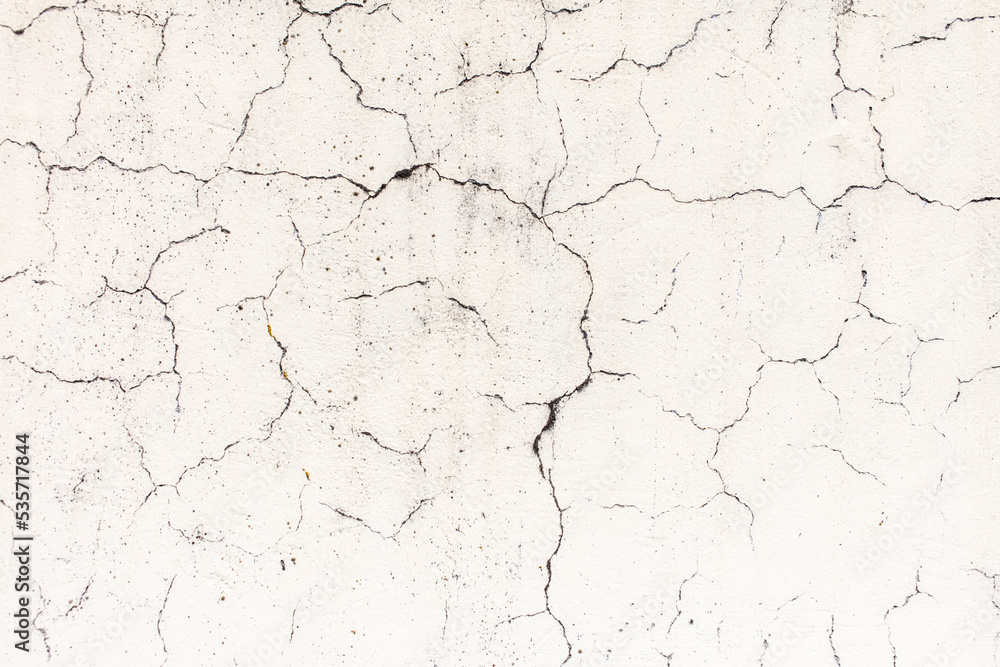 Cracked plaster on the wall of the house.