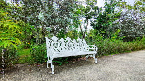 White bench in the green garden