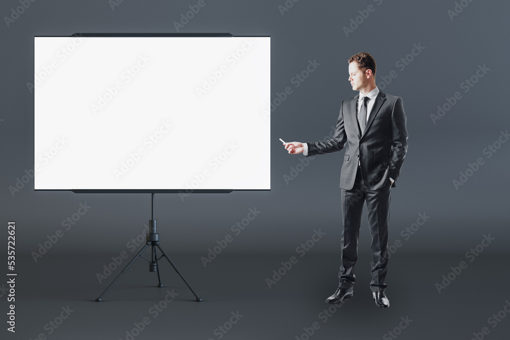 Business education and teamwork concept with man in black suit front view near blank white flip chart with place for your logo or text in abstract room on dark wall background, mockup Business education and teamwork concept with man in black suit front view near blank white flip chart with place for your logo or text in abstract room on dark wall background, mockup