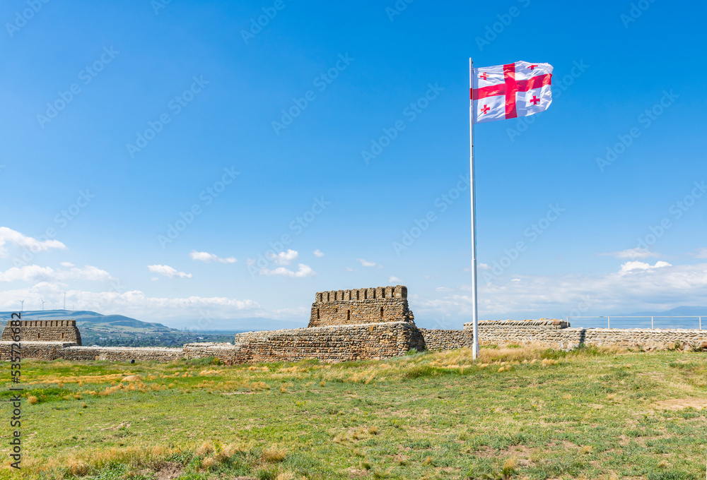 Georgian flag on top of the castle hill in the city of Gori