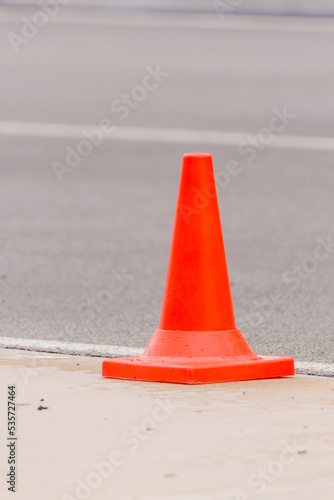 An orange traffic cone is placed on the edge of the racetrack.