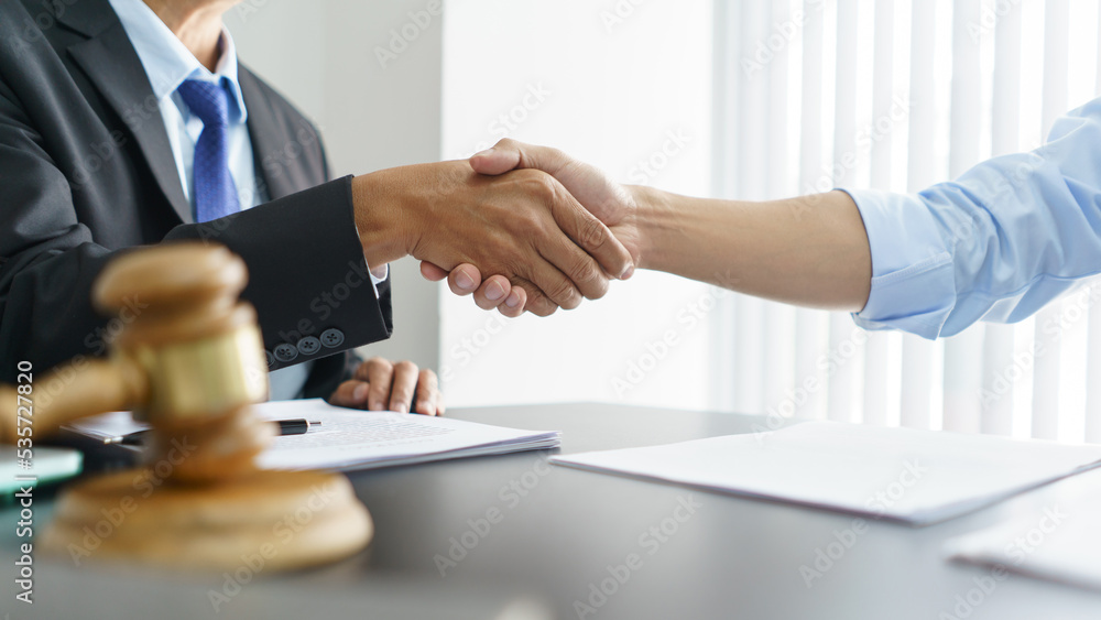Lawyer and legal concept, Businessman and senior lawyer shake hands after successful deal contract Lawyer and legal concept, Businessman and senior lawyer shake hands after successful deal contract