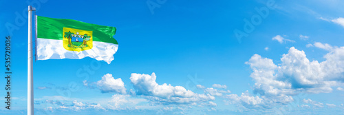 Rio Grande do Norte - state of Brazil, flag waving on a blue sky in beautiful clouds - Horizontal banner photo