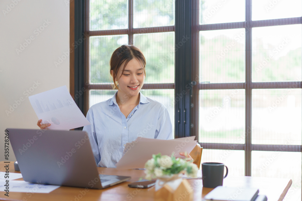 Home office concept, Businesswoman reading data on document to analysis marketing plan of startup Home office concept, Businesswoman reading data on document to analysis marketing plan of startup