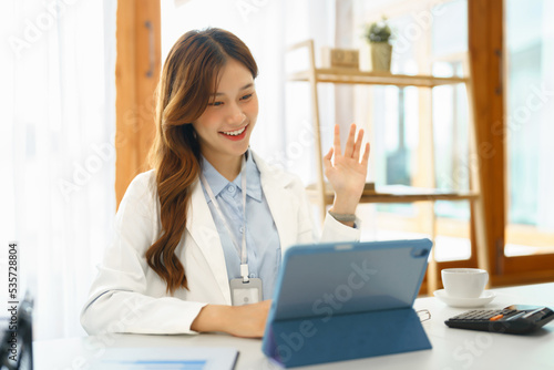 Successful business concept, Businesswoman doing greeting gesture with colleague on video call