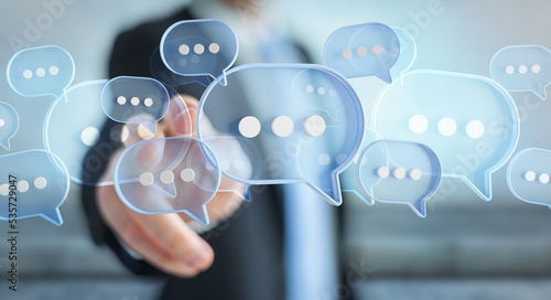 Man touching with his fingers digital speech bubbles talk icons. Minimal conversation or social media messages floating in front of businessman hand. 3D rendering