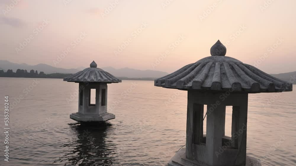 light tower in west lake at sunset in hangzhou light tower in west lake at sunset in hangzhou